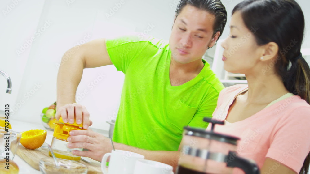 Young Asian Chinese Couple Preparing Fresh Breakfast Juice Young Asian Chinese Couple Preparing Fresh Breakfast Juice