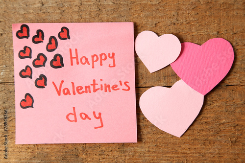 Valentines day note on wooden background