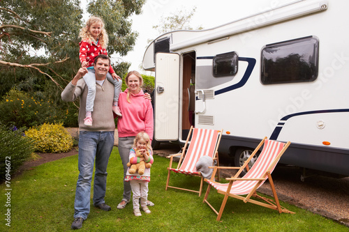 Portrait Of Family Enjoying Camping Holiday In Camper Van