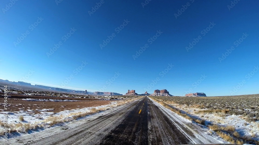POV driving Buttes snow sun flare Colorado Plateau Monument Valley Arizona USA POV driving Buttes snow sun flare Colorado Plateau Monument Valley Arizona USA