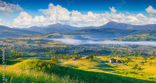 Panorama of the colorful summer morning in mountain village.