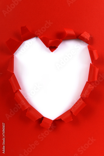 Torn red paper heart shape white background valentine gift opening unwrapping valentines day photo