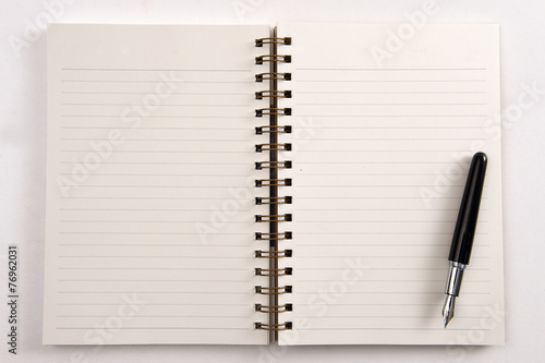 Open notebook and pen isolated on white background