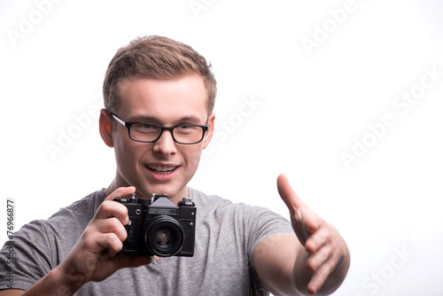 Young handsome man with photo camera