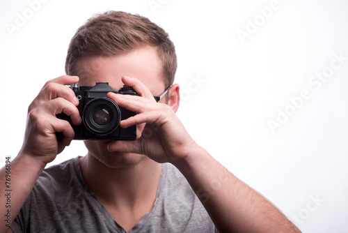 Young handsome man with photo camera © zinkevych