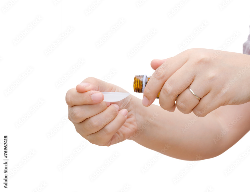 Woman hands pouring medicine in a spoon isolated on white Woman hands pouring medicine in a spoon isolated on white
