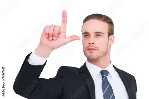 Attentively businessman in suit pointing up