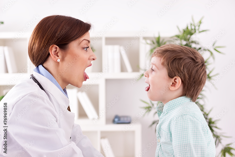 Child patient with doctor showing .tongue, examination.throat Child patient with doctor showing .tongue, examination.throat
