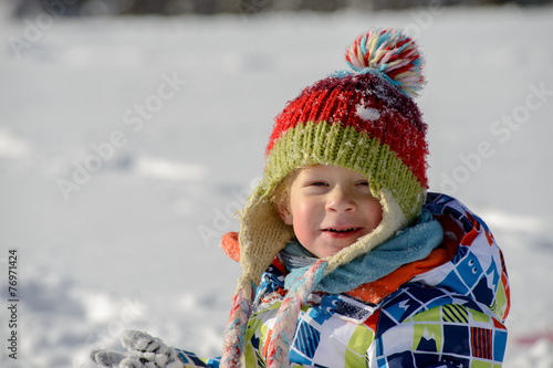little 3 year old child playing in the snow