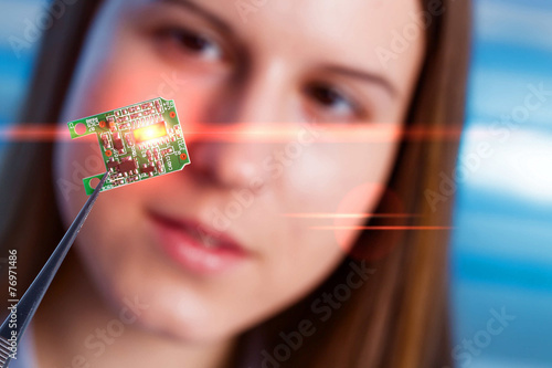 Girl shows new microchip that can be implanted into a paralyzed photo