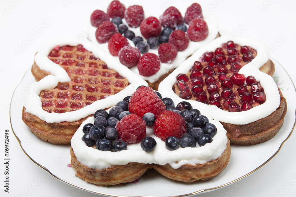 Waffle cookies in the form of hearts decorated with whipped crea Waffle cookies in the form of hearts decorated with whipped crea
