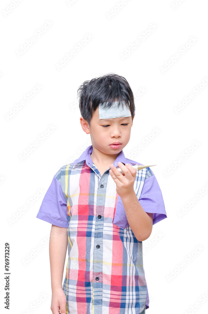 Little sick boy looking at digital thermometer in his hand Little sick boy looking at digital thermometer in his hand