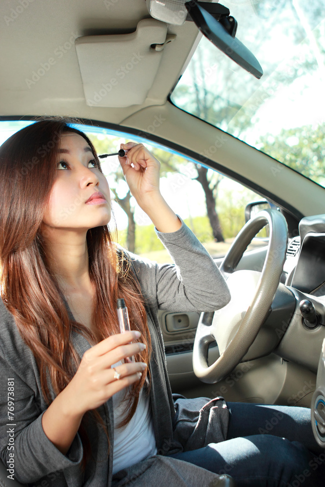 young woman wearing eyeliner in the car