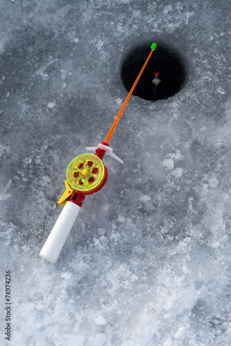 the rod for winter fishing lies near a hole