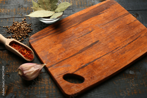 Different spices and herbs with cutting board