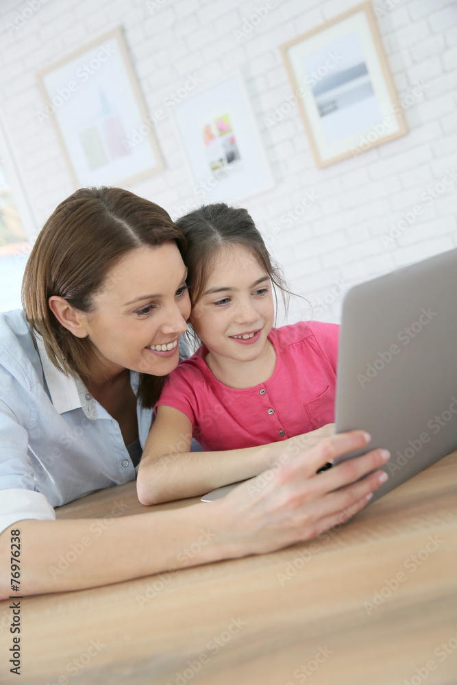 Mother and daughter doing homework on laptop computer Mother and daughter doing homework on laptop computer
