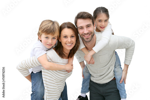 Young parents giving piggyback ride to kids