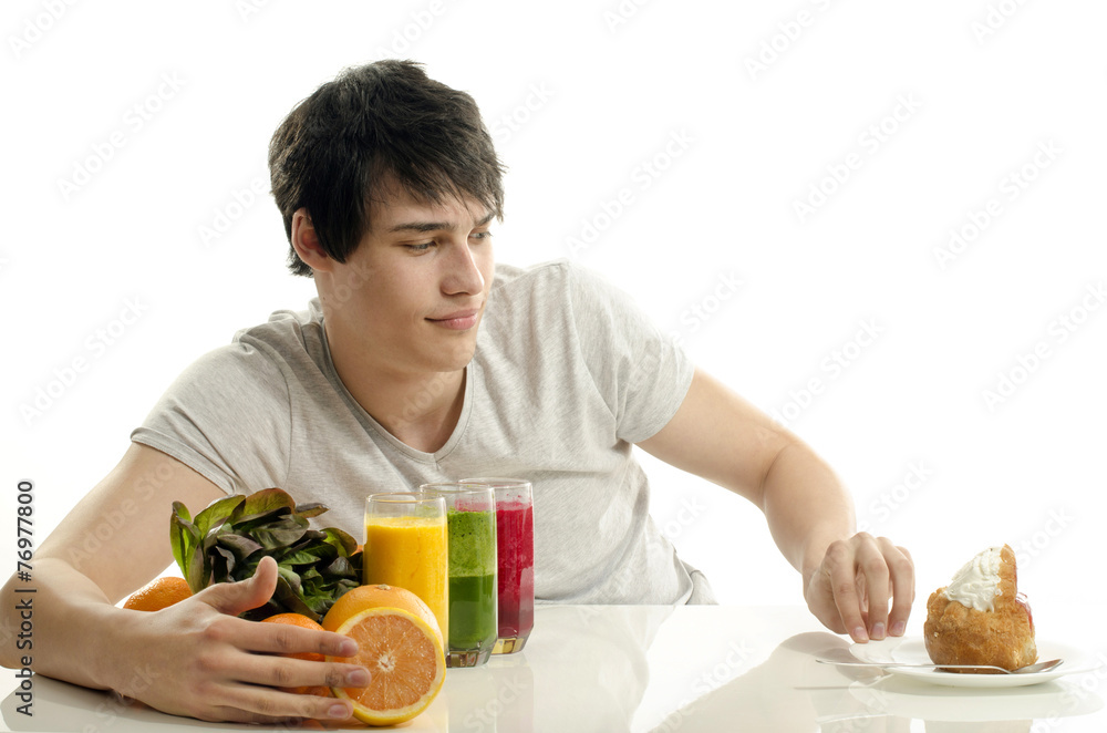 Man choosing between fruits, smoothie,salad and a cake Man choosing between fruits, smoothie,salad and a cake