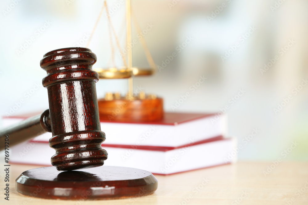Wooden judges gavel on wooden table, close up Wooden judges gavel on wooden table, close up