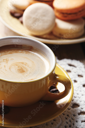 Gentle colorful macaroons and  coffee in mug