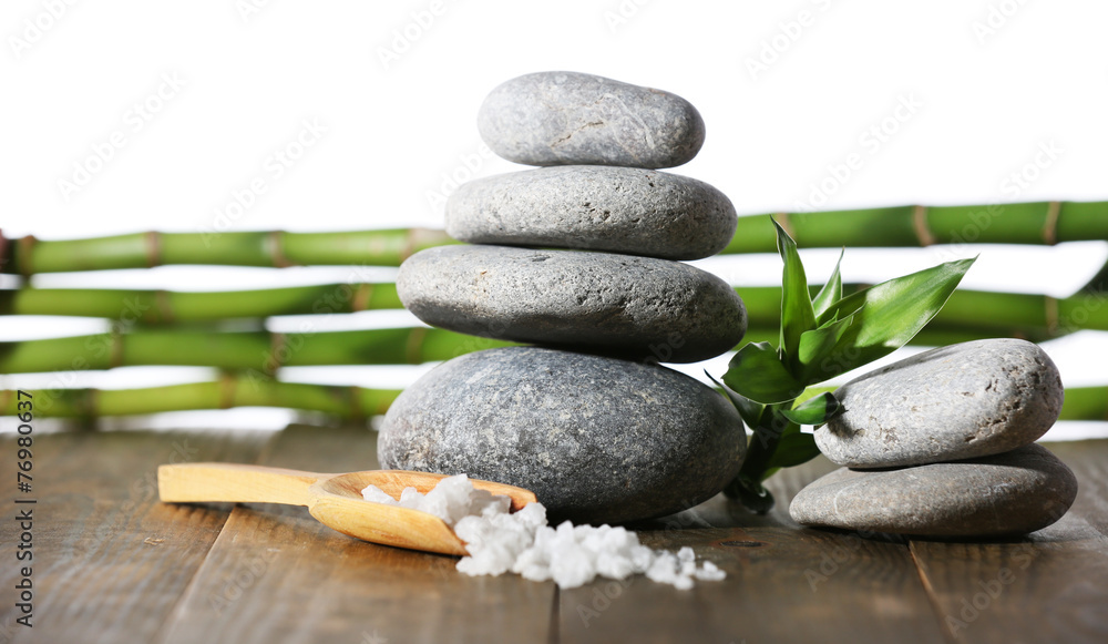 Stack of spa stones with spoon of sea salt Stack of spa stones with spoon of sea salt