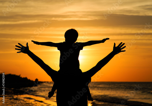 father and son having fun on sunset © nadezhda1906