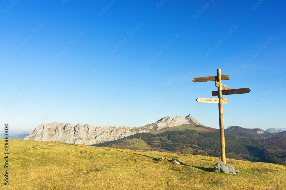 signpost with view of Anboto mountain range signpost with view of Anboto mountain range