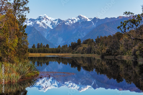 Twin Peaks reflect in the beautiful Lake Matheson, New Zealand © Greg Brave