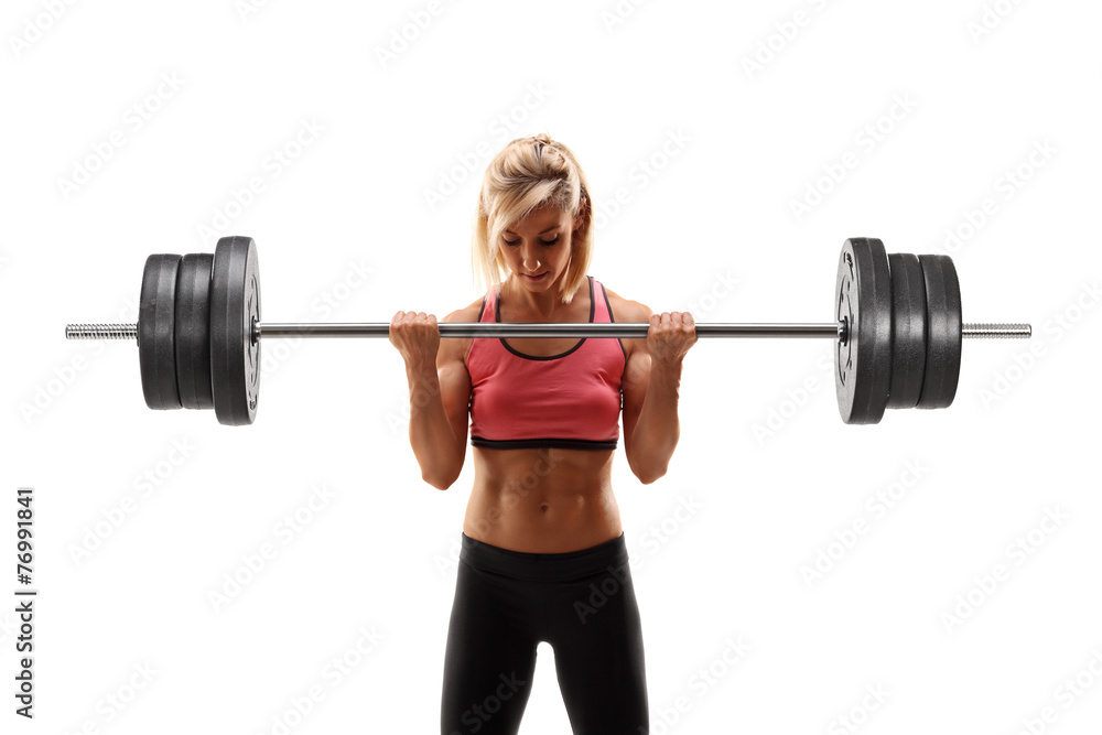Female bodybuilder exercising with a barbell Female bodybuilder exercising with a barbell