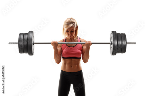 Female bodybuilder exercising with a barbell