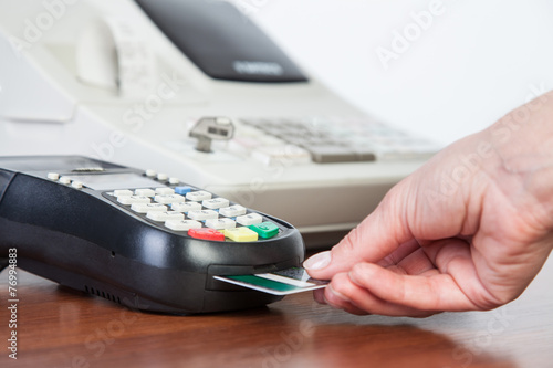 Close-up of cards servicing with POS-terminal photo