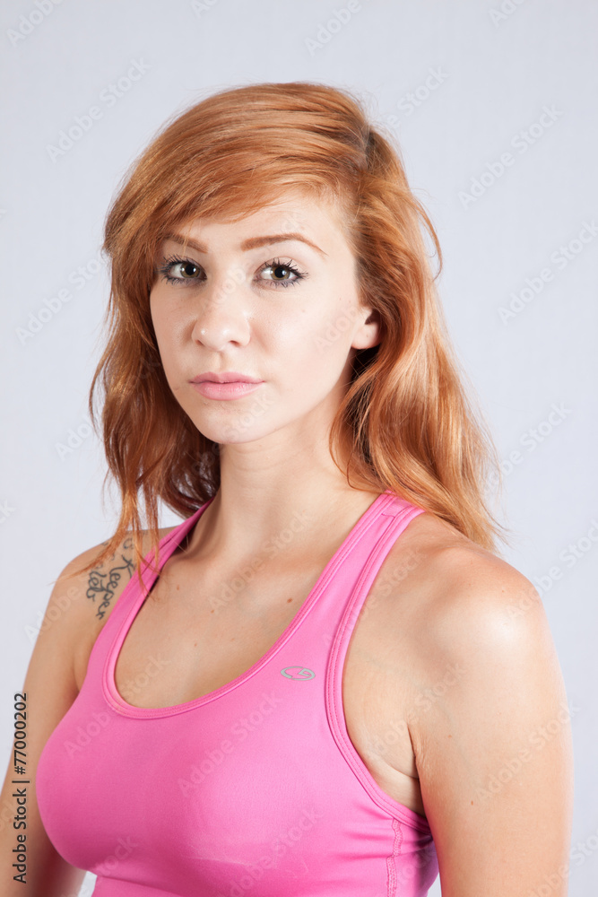 Redhead woman in exercise outfit, looking focused Redhead woman in exercise outfit, looking focused