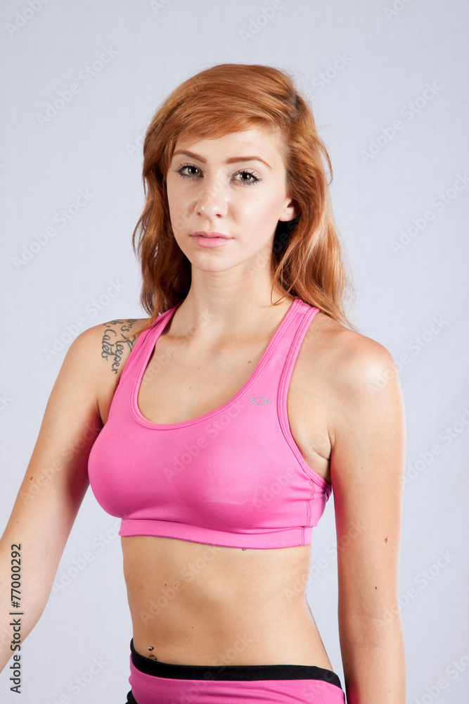 Redhead woman in exercise outfit, looking focused Redhead woman in exercise outfit, looking focused