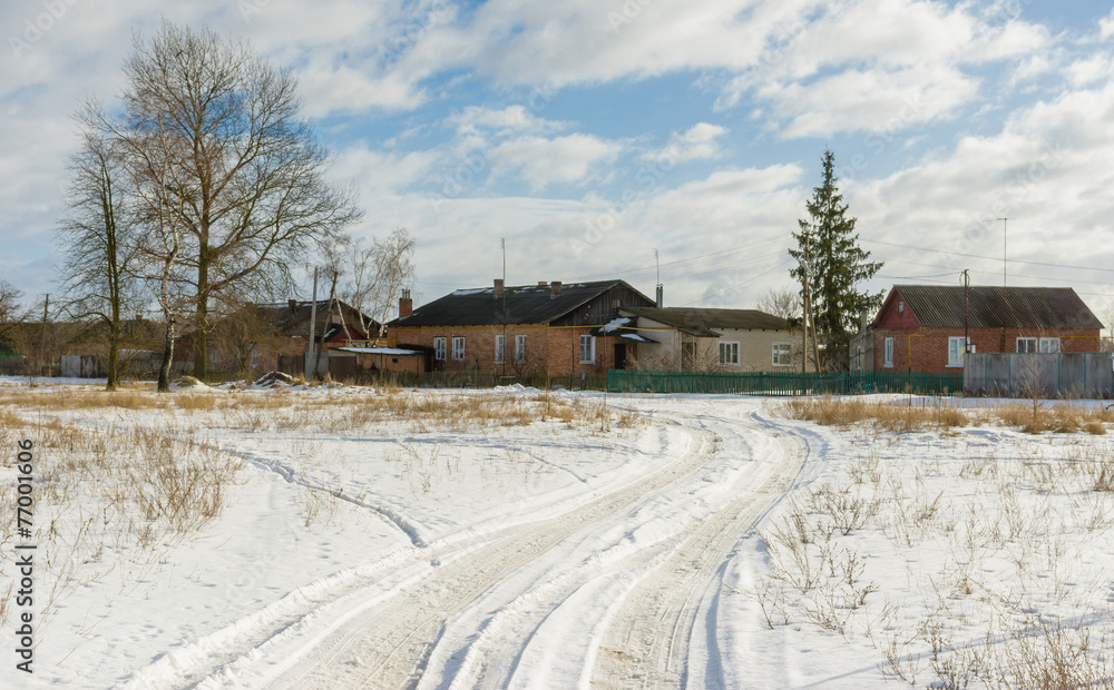 Country road to Ukrainian rural village at winter season