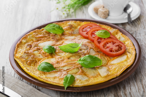 potato omelette with tomatoes on a plate