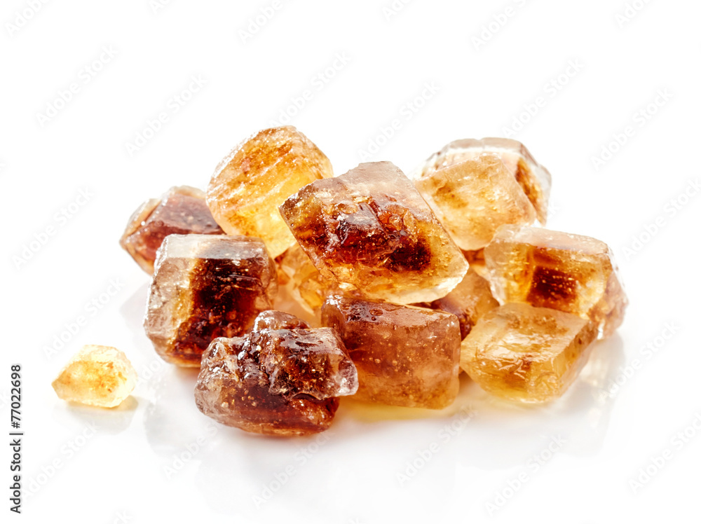 Brown caramelized sugar cubes on a white background Brown caramelized sugar cubes on a white background