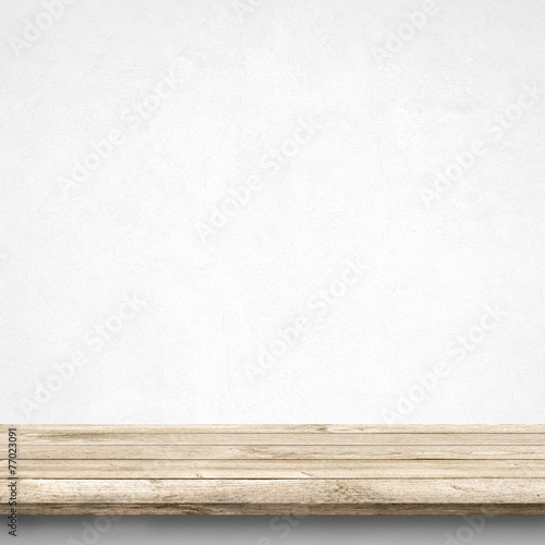 Wood table and white concrete wall