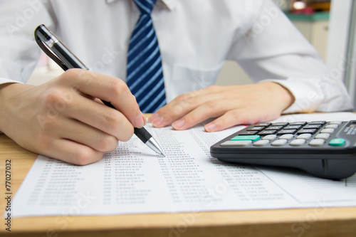 Businessman calculating the financial statements © daizuoxin