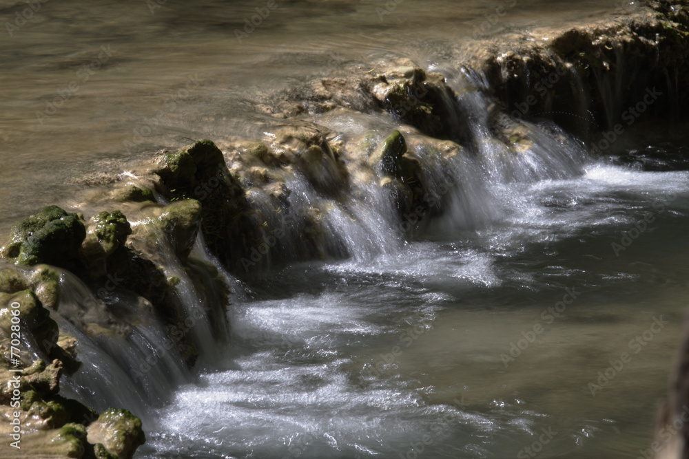 Scenic waterfall with white water cascading over rocks Scenic waterfall with white water cascading over rocks