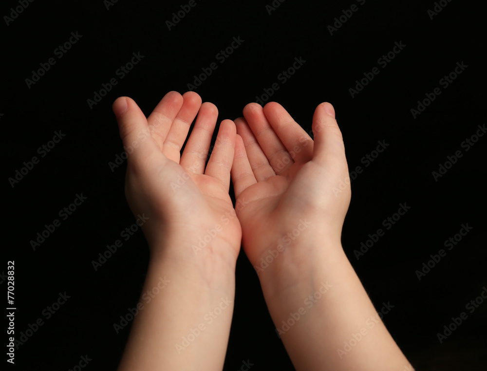 Fototapeta premium Child hands on black background