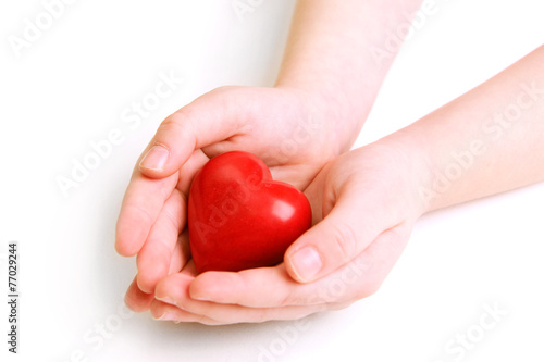 Fototapeta Naklejka Na Ścianę i Meble -  Heart in child hands isolated on white