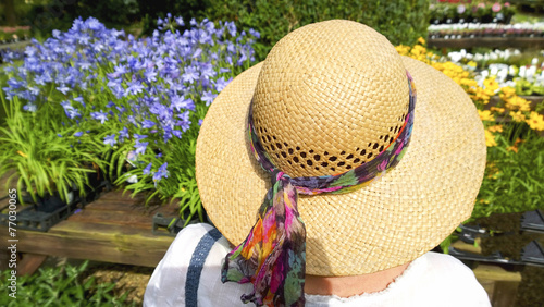 woman in straw hat in garden