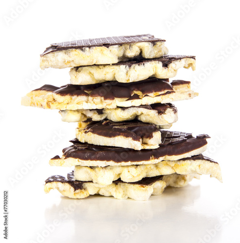 Pieces of chocolate coated rice cakes on white background