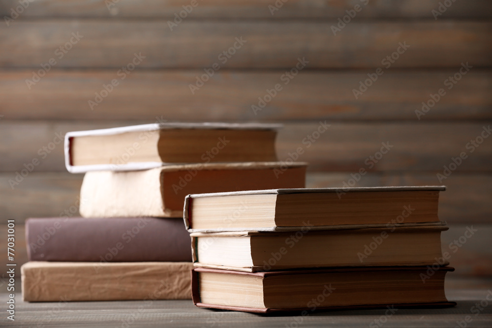 Fototapeta premium Stack of books on wooden planks background