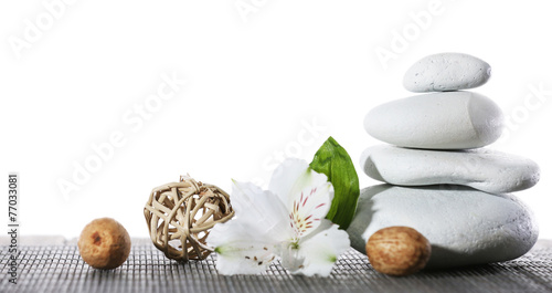 Fototapeta Naklejka Na Ścianę i Meble -  Still life of spa stones on bamboo mat surface isolated on