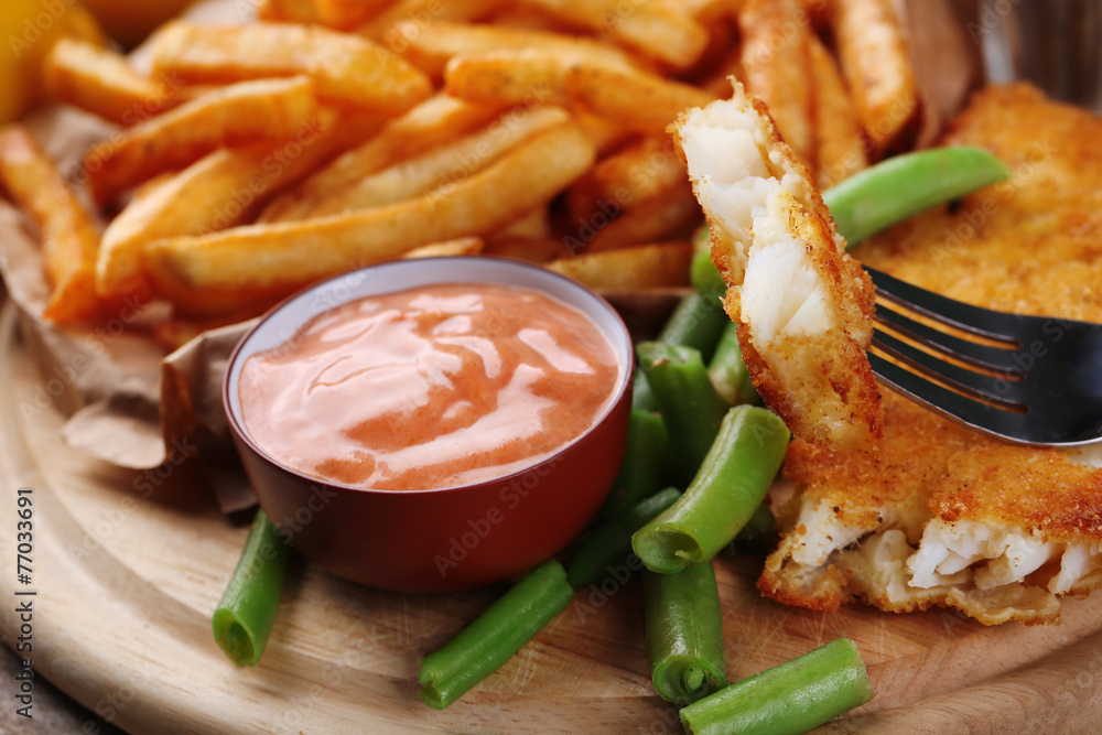 Breaded fried fish fillet and potatoes with asparagus and sauce Breaded fried fish fillet and potatoes with asparagus and sauce