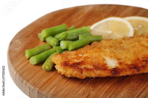 Breaded fried fish fillet and potatoes with asparagus and
