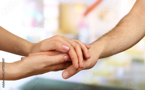 Male and female hands on light background