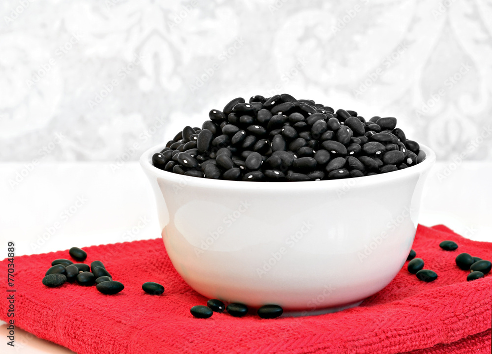 Black turtle beans in a white bowl. Black turtle beans in a white bowl.