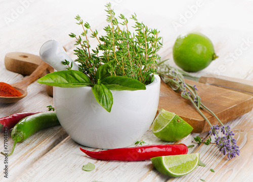 Fresh herbs and  chili peppers on  wooden background.